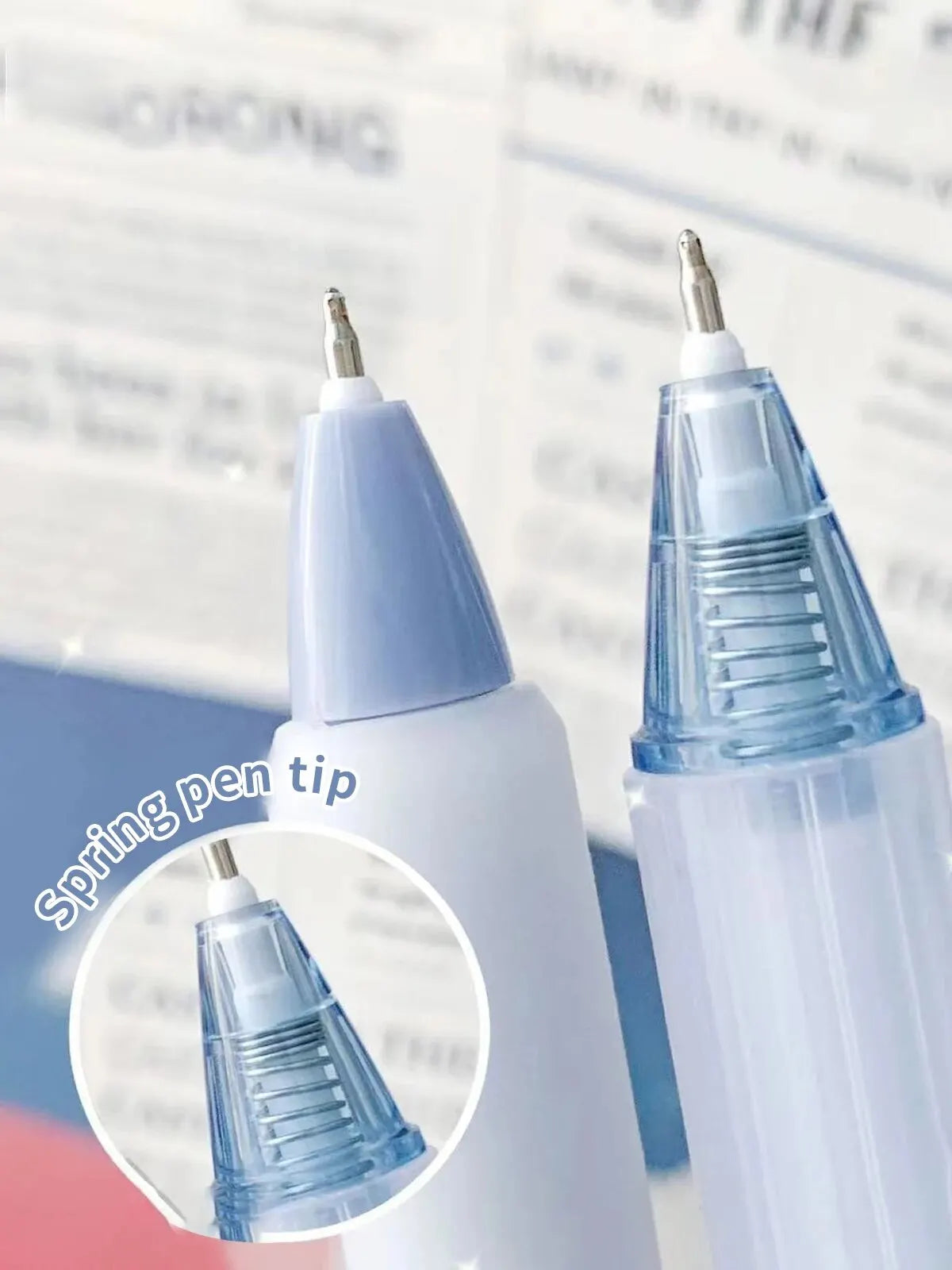 Close-up view of a white gel pen with a silver spring tip and a blue pen showing the tip detail.