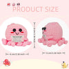Pink crochet octopus plush doll showing size comparison with a ruler.