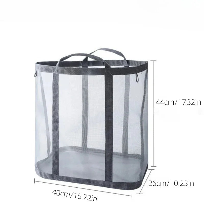 A clear mesh laundry basket with a handle and black straps, shown in a side view.