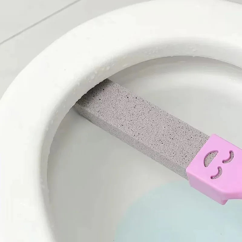 A pink reusable pumice stone cleaning stick is shown inside a white toilet bowl.
