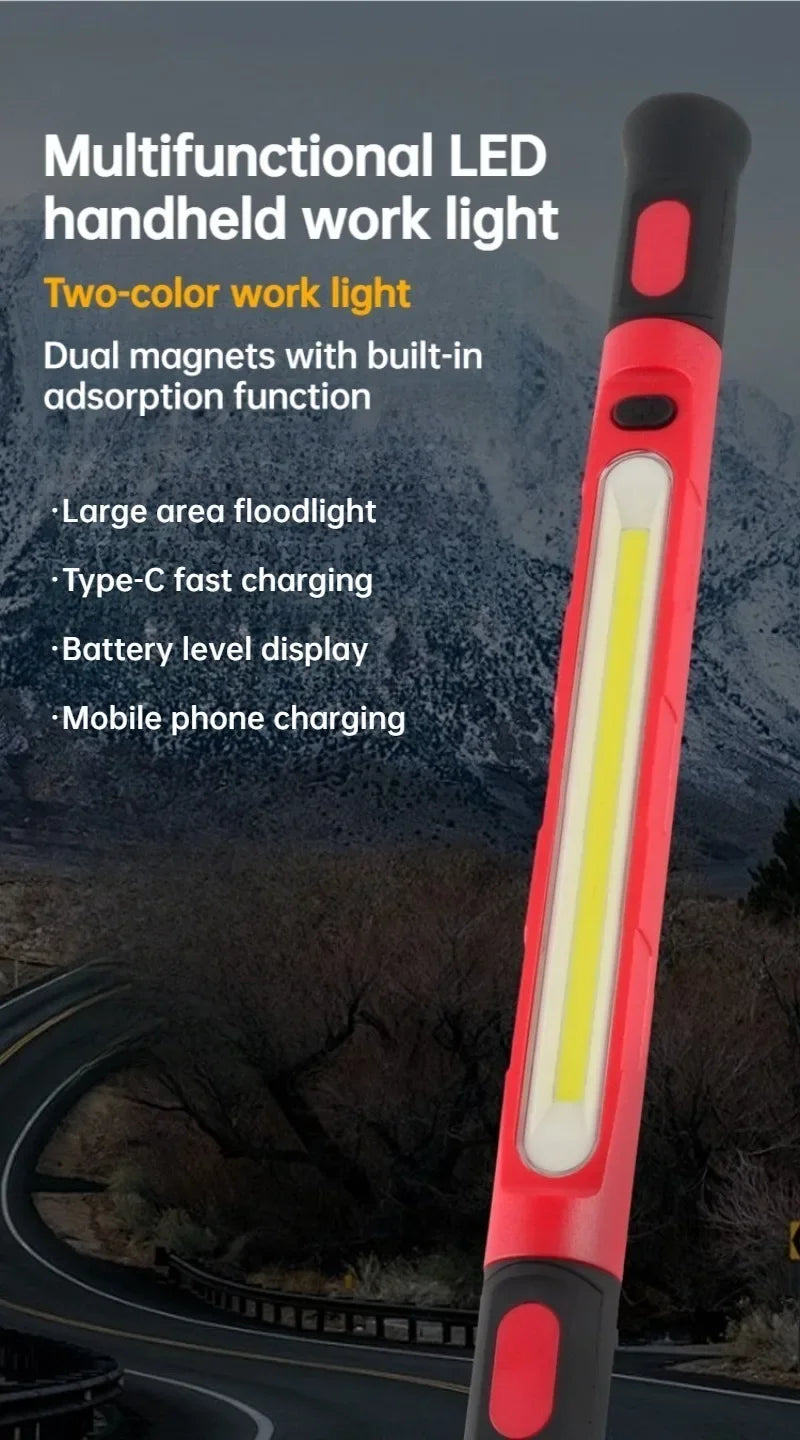 A red and black multifunctional LED handheld work light with a bright yellow floodlight, shown outdoors.