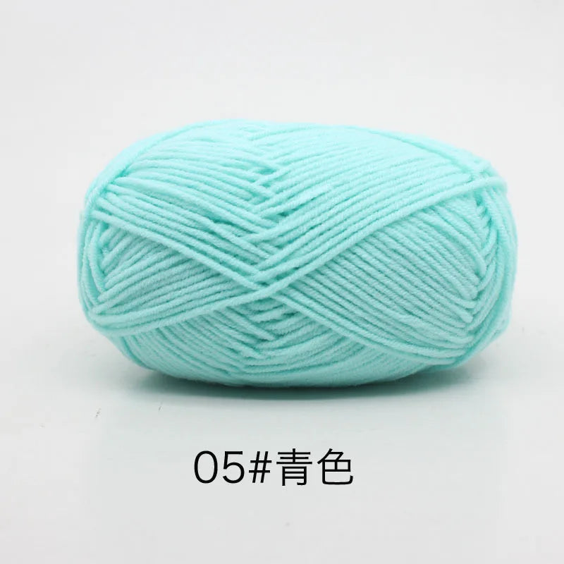 A ball of light blue soft 4-ply milk cotton yarn for knitting and crochet.
