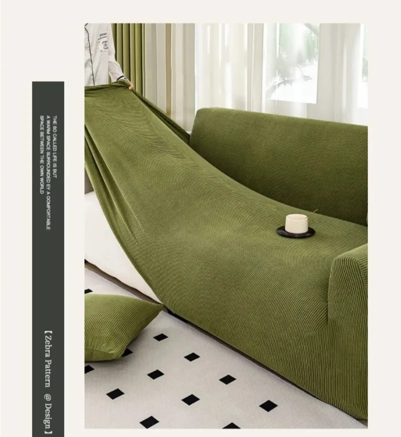 A deep olive green stretch jacquard sofa cover with a textured fabric and non-slip elastic edge.