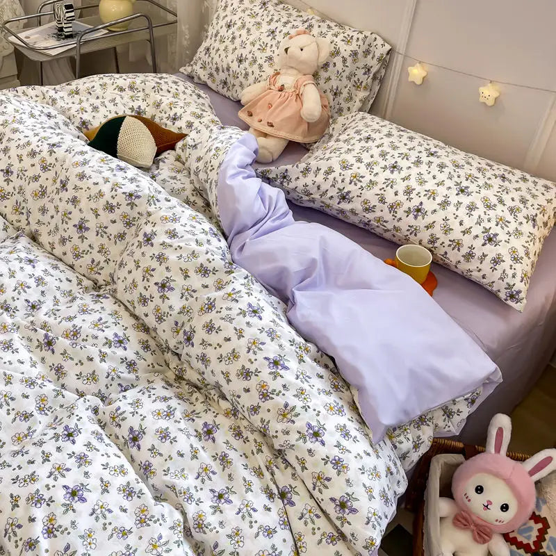 Pink floral bedding set featuring a duvet cover and pillowcases with a white and green patterned fabric.