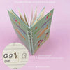 A stack of colorful handwriting practice books featuring a groove design to improve kids' writing habits.