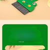 A green cartoon broom and dustpan set for tabletop cleaning is shown on a light background.