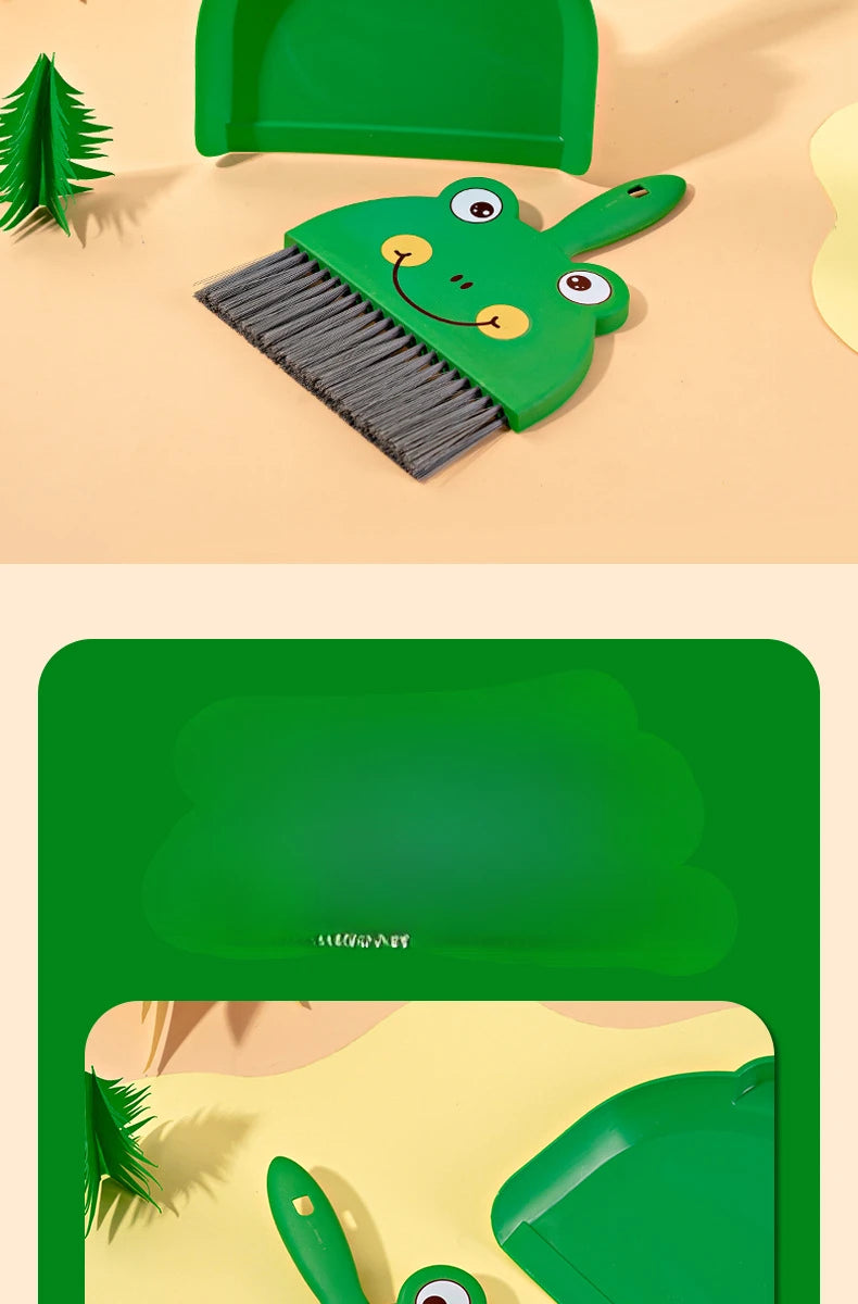 A green cartoon broom and dustpan set for tabletop cleaning is shown on a light background.