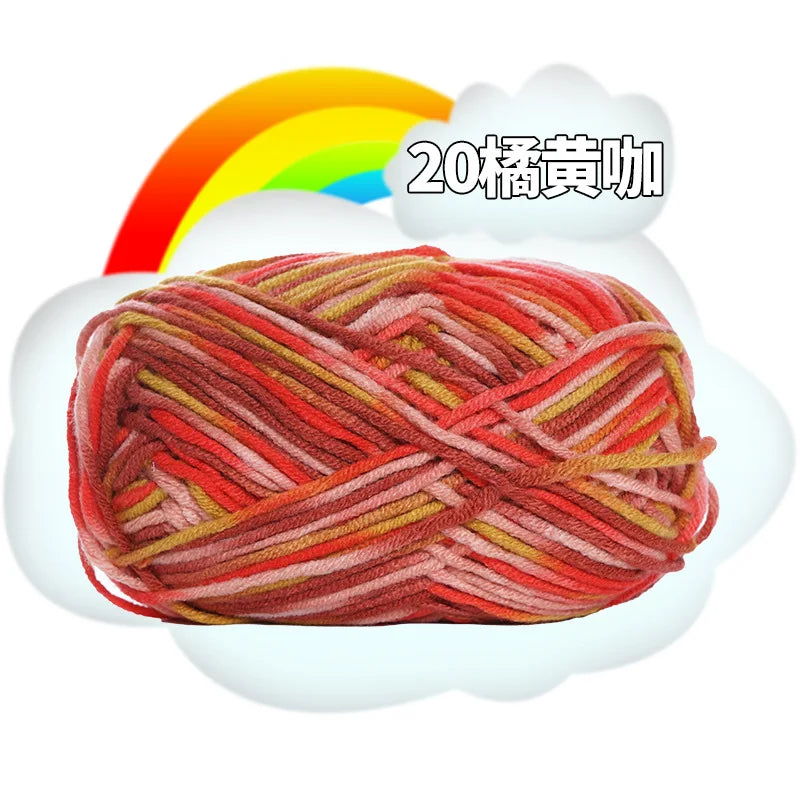 A ball of red and orange milk cotton blend yarn is shown against a white cloud with a rainbow background.