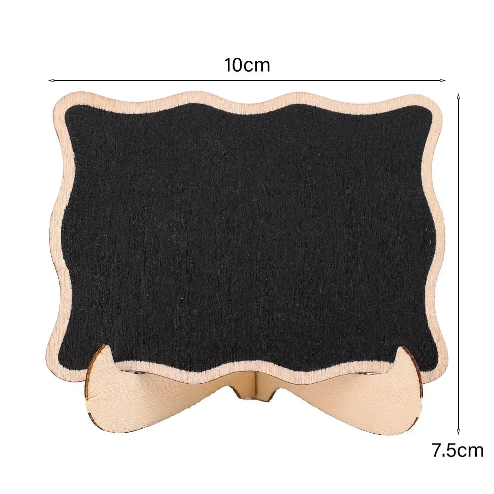 A small wooden chalkboard sign with a black surface and light wood frame, measuring 10cm by 7.5cm.