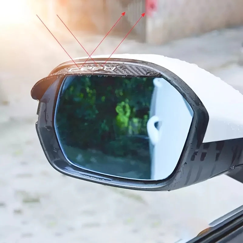 A close-up view of a carbon fiber rearview mirror rain guard mounted on a vehicle.