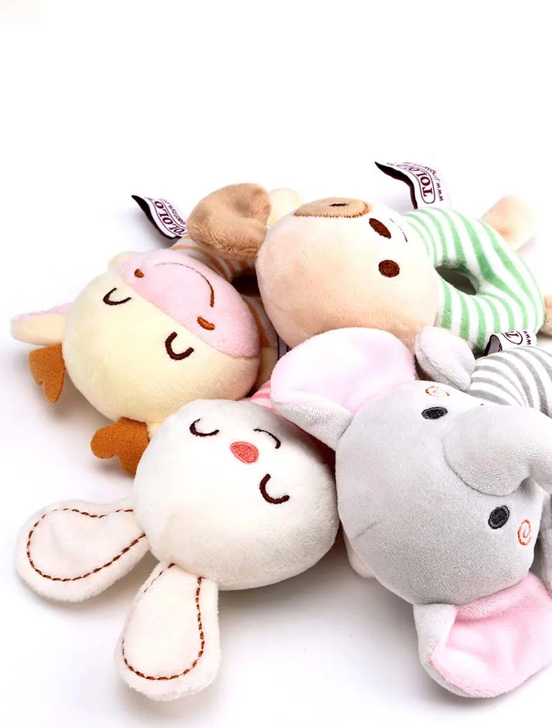 A collection of soft plush baby rattle toys featuring cartoon animal designs like a bear and a rabbit.