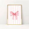 Pink bow canvas print featuring vertical pink and white stripes in a gold frame.