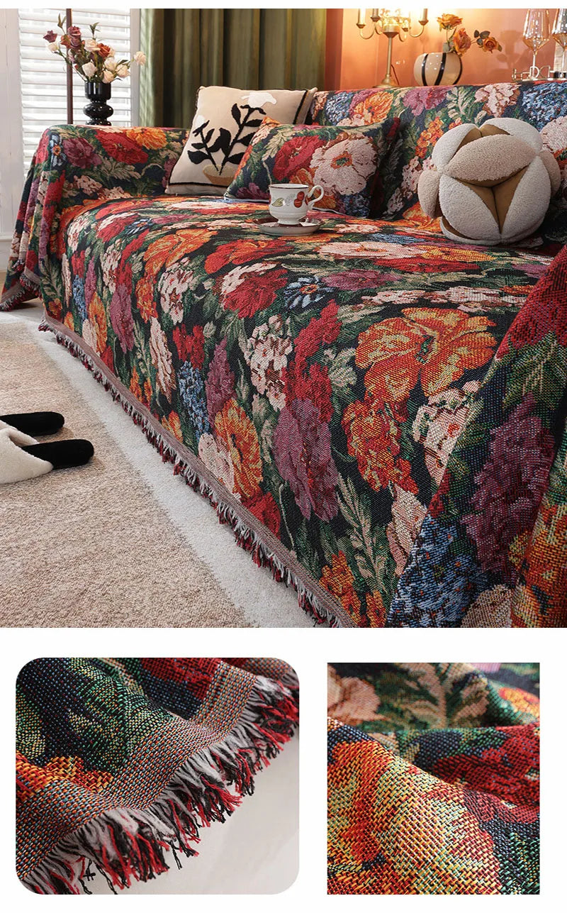 A richly colored floral jacquard sofa blanket with tassels draped over a sofa.