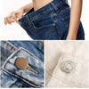 Close-up of a pair of dark denim jeans showing a bronze no-sew button set on the pocket