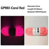 Spool of bright pink glow-in-the-dark polyester yarn for knitting and crochet