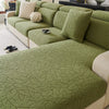 A section of a moss green jacquard fleece sofa cover with an embossed leaf pattern and anti-slip backing.