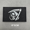 Black embroidered patch featuring a white skull and crossbones design with a stylized sword above it.