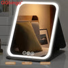 A portable touch vanity mirror with customizable LED lights showing a close-up of a textured pillow.