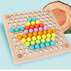 A wooden bead maze puzzle with colorful plastic beads arranged in a grid on a light wood board next to a slice of wood.