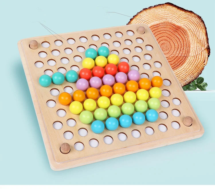 A wooden bead maze puzzle with colorful plastic beads arranged in a grid on a light wood board next to a slice of wood.