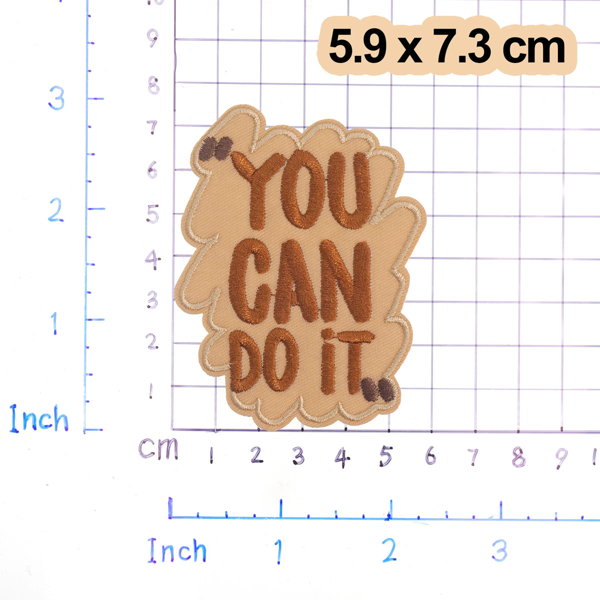 A brown embroidered patch with the text YOU CAN DO IT on a light tan background.