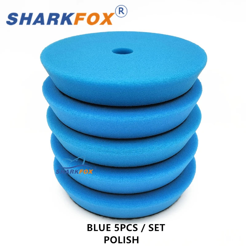 A set of five blue polishing sponge pads for car detailing and paint correction.