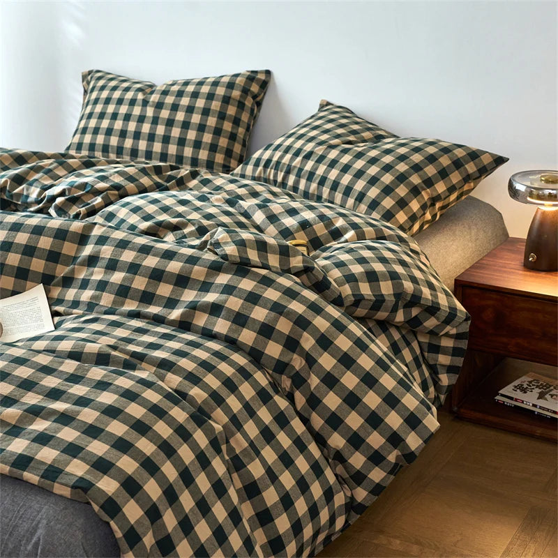 A plaid duvet cover in olive green and beige tones with a grid pattern displayed on a bed.