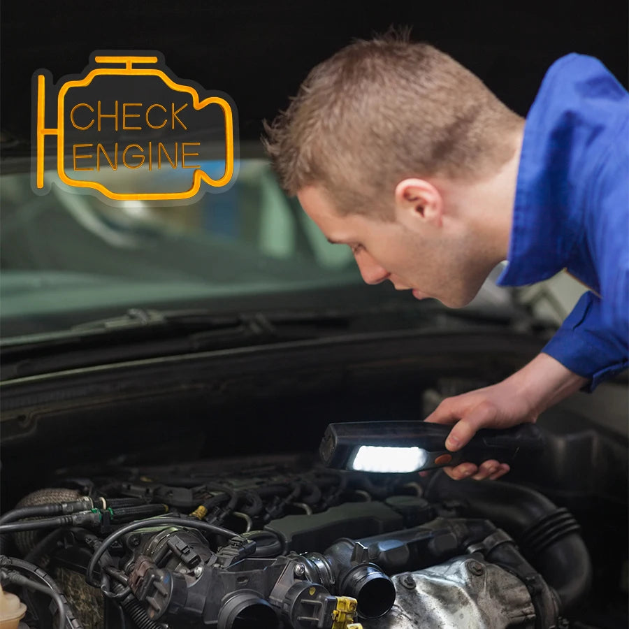 A person is using an oil change neon sign to check the engine of a car.