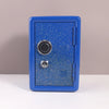 A blue vintage metal piggy bank with a combination lock and key.