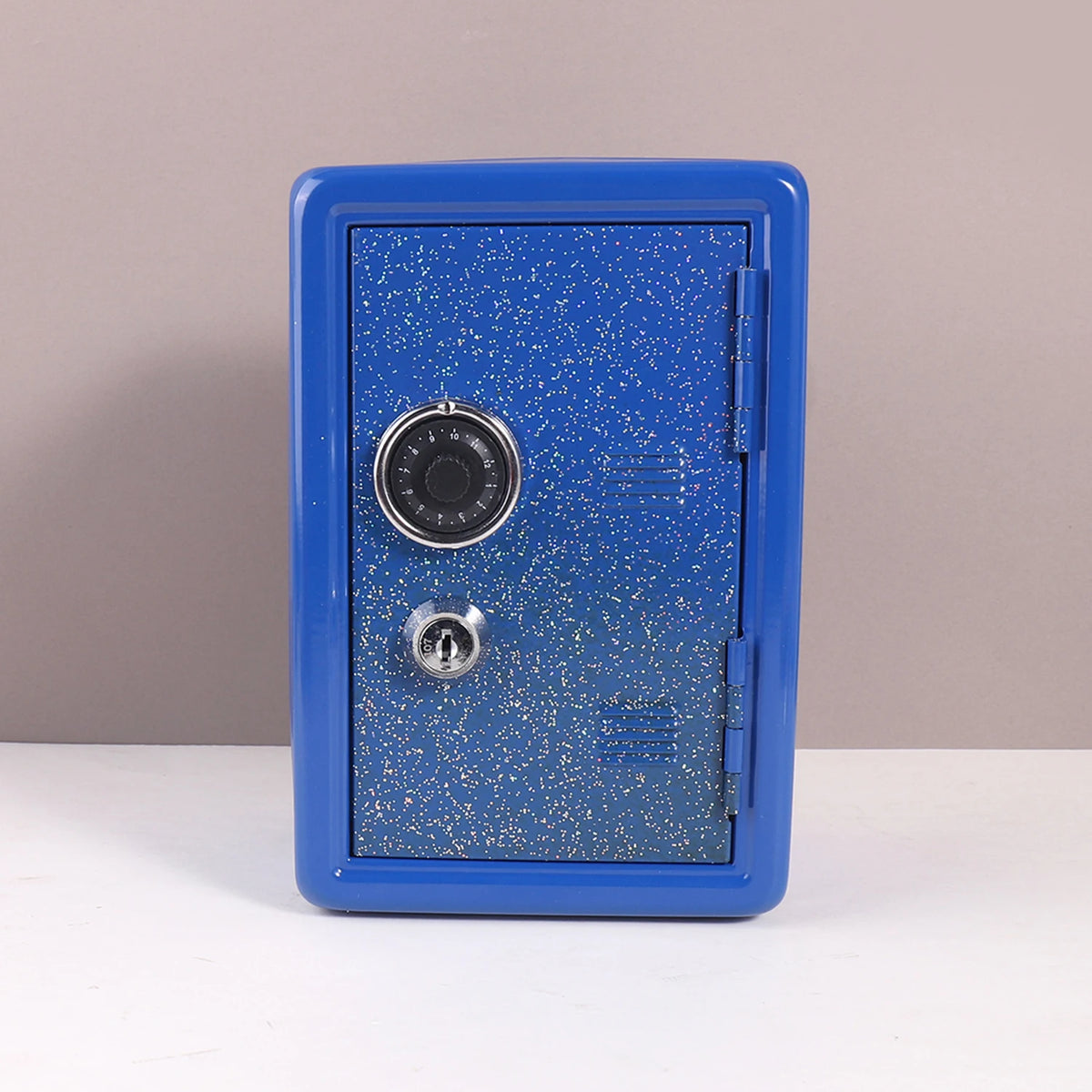 A blue vintage metal piggy bank with a combination lock and key.