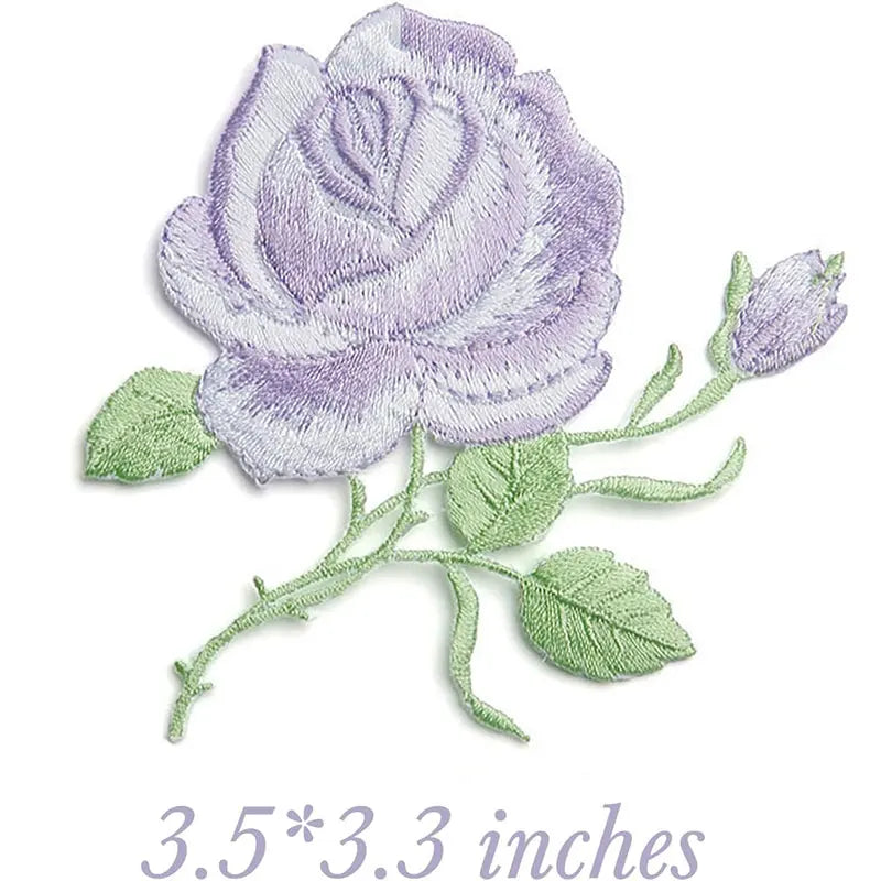 Embroidered iron-on patch featuring a purple rose with green leaves and a butterfly detail