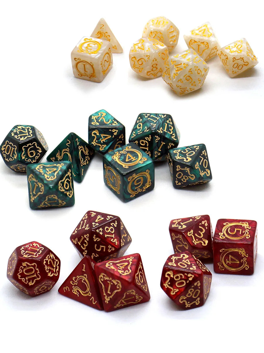 A collection of dragon-embellished polyhedral dice in gold and green colors.
