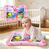 A baby is playing on a pink inflatable ocean-themed water play mat with colorful sea creatures.