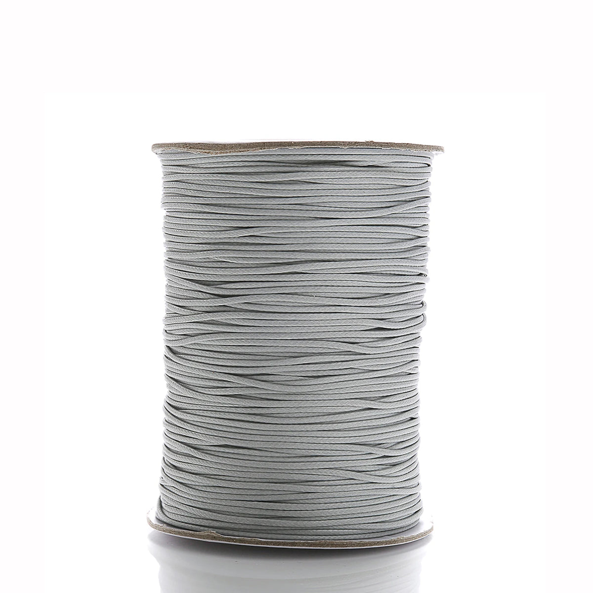 A spool of gray waxed cotton cord used for jewelry making