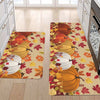 An area rug featuring an autumn design with pumpkins and maple leaves on a light background.