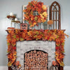 An artificial maple leaf garland in autumn colors decorates a fireplace mantel and hearth.