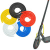 A collection of colorful cable protector sleeves in yellow, black, red, and blue arranged in a circular pattern.