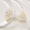 A bundle of 400 pearl flower stamens for DIY crafts and wedding decor placed on a white plate.