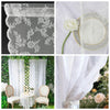 Two panels of vintage floral lace sheer curtains with delicate embroidery and a white rose accent.
