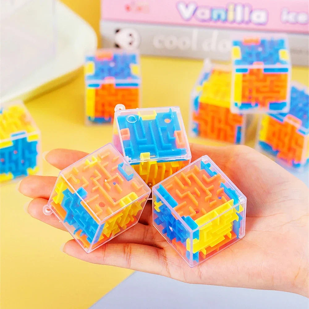 A hand holds a transparent cube puzzle with colorful maze patterns, demonstrating the 3D maze cube.
