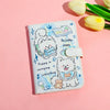 A light blue cartoon puppy design on a white leather passport holder with floral accents.