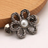 Silver adjustable flower waist clip with a pearl center and gold accents
