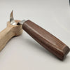 A wooden carving tool with a metal blade and walnut handles is shown on a white background.