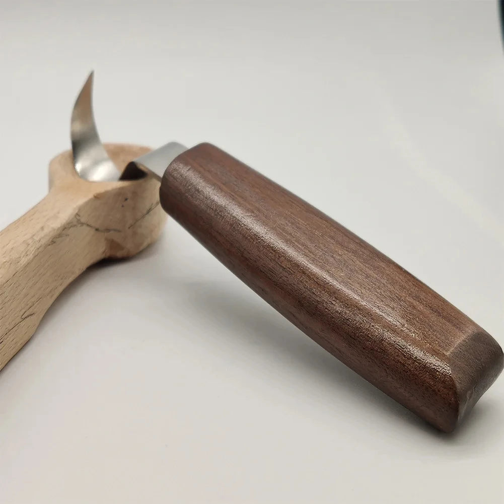 A wooden carving tool with a metal blade and walnut handles is shown on a white background.