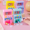 A set of colorful interactive vending machine toys featuring plastic bottles and play coins on a pink surface.