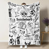 A white throw blanket featuring various black and white illustrations of skulls, clowns, and horror themes.