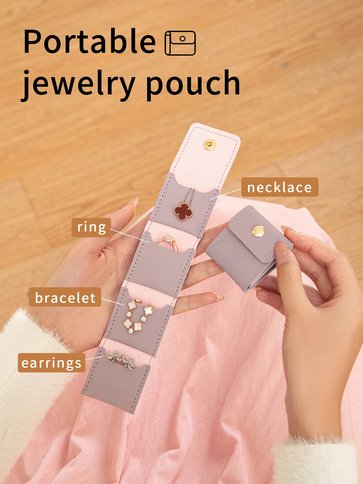 A hand holds a portable jewelry pouch with four compartments for organizing rings, bracelets, earrings, and necklaces.