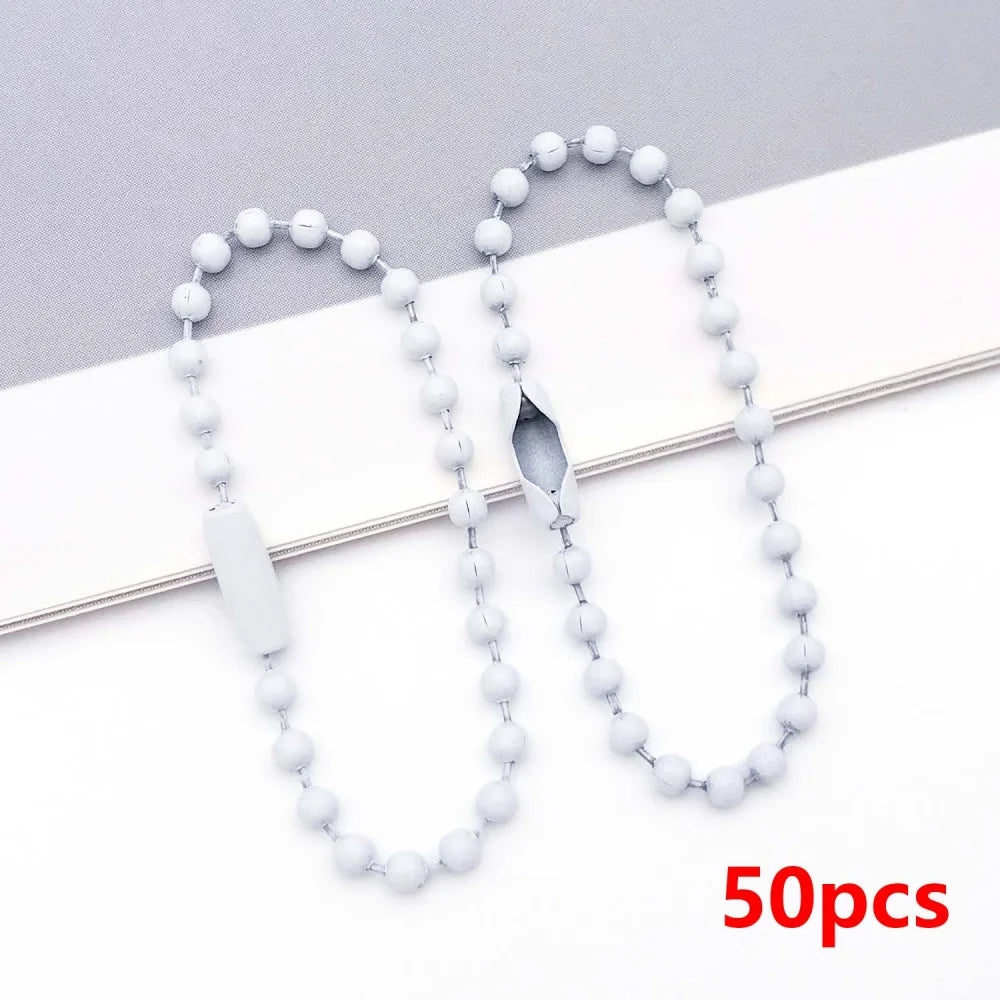 A string of small white ball beads is displayed on a white background, showing various lengths and a bead with a slit.