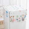 A white refrigerator covered with a floral pattern dust cover featuring colorful shapes and storage pockets.
