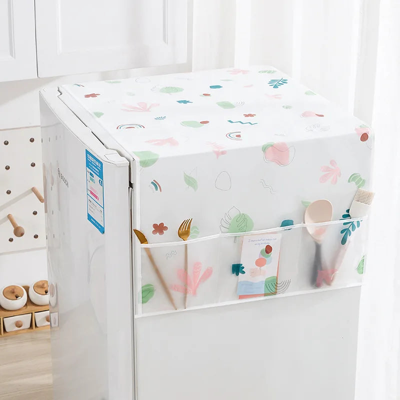 A white refrigerator covered with a floral pattern dust cover featuring colorful shapes and storage pockets.